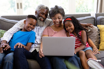 Senior mixed race couple with their grandchildren