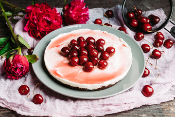 Fresh cheesecake with cherries on the rustic background. Selective focus. Shallow depth of field.
