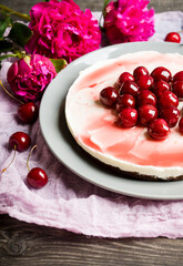Fresh cheesecake with cherries on the rustic background. Selective focus. Shallow depth of field.
