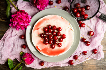 Fresh cheesecake with cherries on the rustic background. Selective focus. Shallow depth of field.
