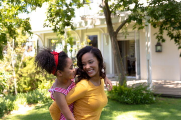 Fototapeta premium Mother and daughter having fun together in the garden