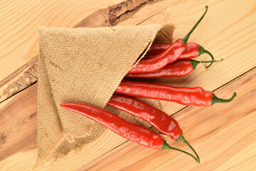 Red chili peppers, close-up, on a wooden table.