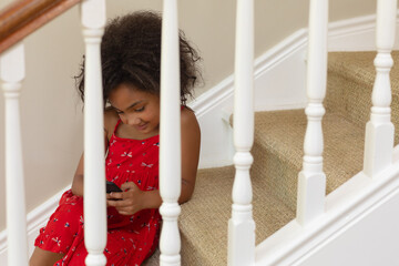 Young mixed race girl using a smartphone