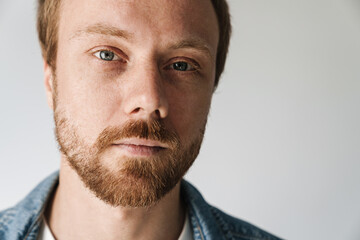 Fototapeta premium Photo of caucasian young man with red hair posing and looking on camera