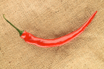 Red chili peppers, close-up, on jute fabric.