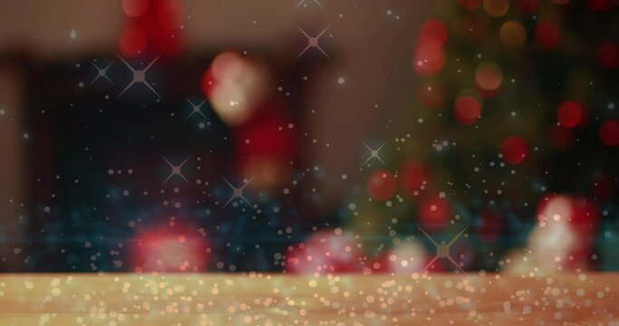 Digital composite video of glowing spots moving against Christmas tree in background