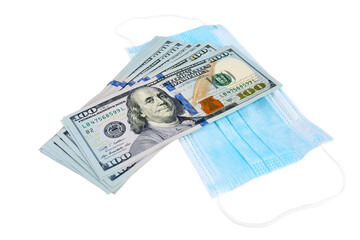 Blue medical face masks and stack of 100 USD banknotes. Isolated on white.