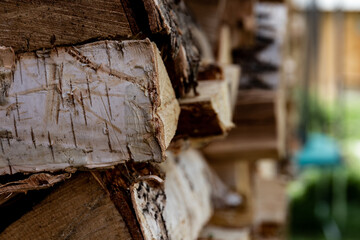 Fototapeta na wymiar folded woodpile firewood outdoors in a village on a bright summer day