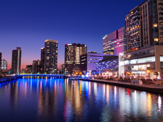 Fototapeta na wymiar 夕暮れの大阪 ほたるまちのビル群とライトアップされた玉江橋