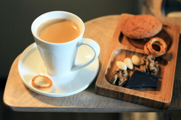 Coffee in a cup and nuts for breakfast