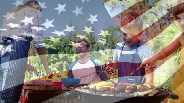 Caucasian family doing barbecue with US flag waving foreground
