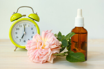 Rose and bottle with aromatic oil or medicine.