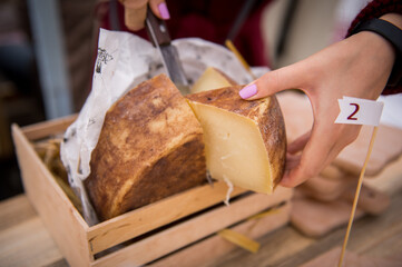 Hard Cheese Festival. Cheese in the market. Homemade cheese. Craft cheese. Milk product.