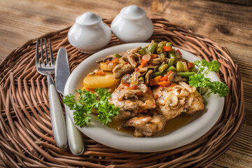 Fillet of chicken legs with stewed vegetables.