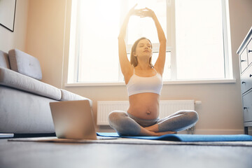 Healthy pregnancy with pleasant yoga asana at home - obrazy, fototapety, plakaty