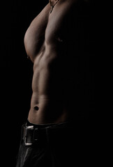 Part of a man's body on a dark background with copyspace