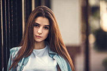 Fashion hipster cool girl relaxing on city street