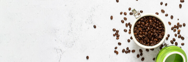 can with coffee and coffee beans scattered on a concrete background. Banner. Concept of fresh coffee, breakfast, plantation. Top view, flat lay