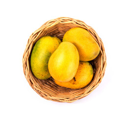 Fresh organic yellow mango In the basket on white background. Tropical fruit. Top view of ripe...