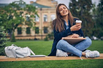 Young smiling lady with cup of coffee