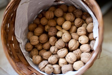 Shelled walnuts in the basket. Natural and organic village walnuts. There is also some shelled almonds in the basket. 