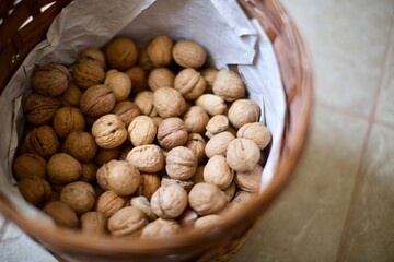 Shelled walnuts in the basket. Natural and organic village walnuts. There is also some shelled almonds in the basket. 