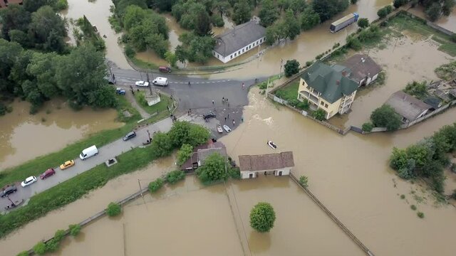 Flooded neighborhood street. Major flooding leaves city, underwater, entire community. Homes, houses overflowing water, insurance needed. Rescue teams helping people Ivano-frankivsk Galych, Ukraine