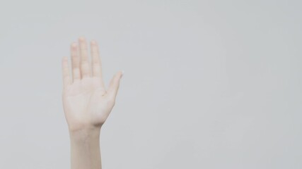 Goodbye gesture. Farewell sign. Female waving hand isolated on gray empty space background.