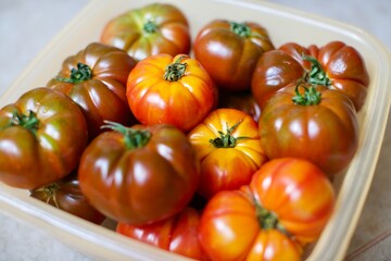 Close-up view of fresh tomatoes. Organic tomatoes grown in the village and standing in the basket. 