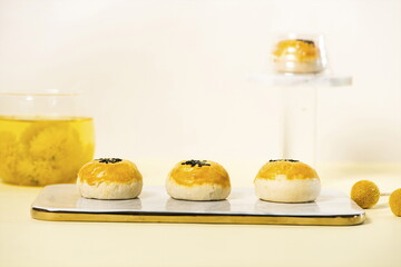 Homemade egg-yolk puff for dessert, with a cup of chamomile tea on the side