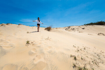 Happy woman on White sand dunes in Vietnam