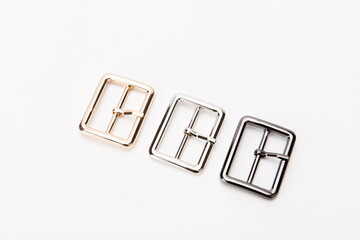 Various styles of belts with metal buckles on a white background