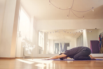 Athletic young man doing child pose or balasana