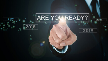 Man standing and pointing hand with ARE YOU READY? TEXT Visual Graphic on Light and star background. COPY SPACE. Business Concept : Market Uptrend and Forecast 2020.