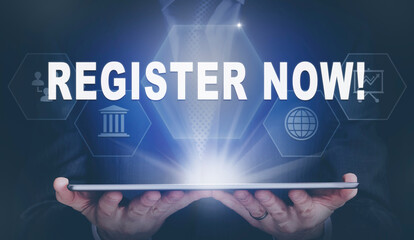 Businessman holding a computer tablet display projecting a Register Now concept.