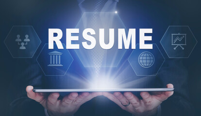 Businessman holding a computer tablet display projecting a Resume concept.