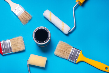 Tin can with paint and lot of different decorator brushes