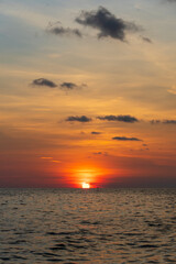 Sunset on the island of Phu Quoc, Vietnam. Travel and nature concept. Evening sky, clouds, sun and sea water