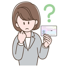 マイナンバーカードを持って悩むスーツの女性