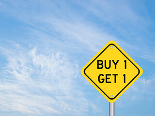 Naklejka premium Yellow color transportation sign with word buy 1 get 1 on blue cloud sky background