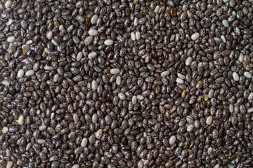 Macro photo of chia seeds. Superfoods, healthy black seeds organic, source of omega 3, calcium and iron. Proper nutrition, diet and health care.