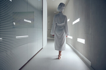 Female wearing a bath towel on her head - obrazy, fototapety, plakaty