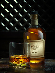 NO LOGOS OR TRADEMARKS!  SELF MADE LABELS! close up view of bottle of whiskey and a glass aside on color back. 
