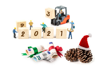 miniature worker team building standing front of forklift machine with   2021 number on wooden block on white background decoration to Happy new year 2021 concept.
