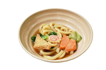 Udon with Shoyu or Japanese rice noodles topping fried tofu and slice fish ball in soybean soup in bowl