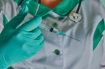 Nurse with syringe in green gloves. Syringe, medical injection, palm or fingers. Medicine plastic vaccination equipment with needle. Nurse or doctor. Liquid drug or narcotic. Health care in hospital.