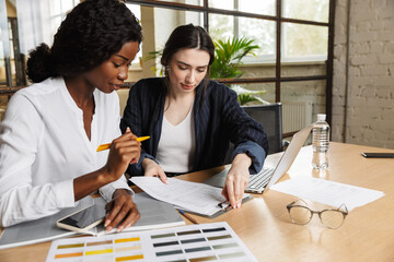 Two attractive smart multiethnic women entrepreneurs