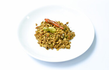 fried minced pork with flat bean in yellow curry on plate