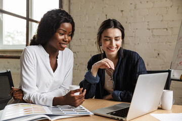 Two attractive smart multiethnic women entrepreneurs