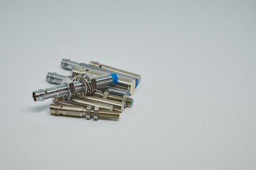 Many Inductive proximity sensor or proximity switch on a white background.